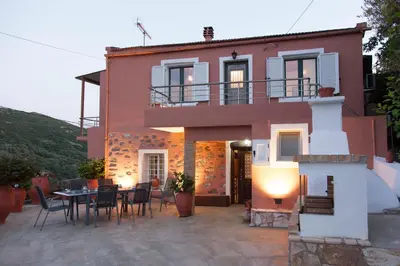 a house with a table and chairs in front of it at Villa Olea-Renieri in Grigorianá