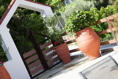 a group of potted plants sitting on a fence at Villa Olea-Renieri in Grigorianá