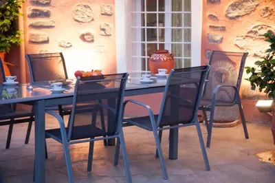 a blue table and chairs with a bowl of fruit on it at Villa Olea-Renieri in Grigorianá