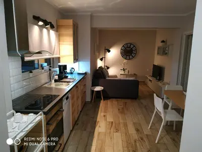 a kitchen and living room with a table and a couch at Evan's place in Chorafakia