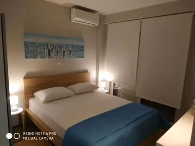a bedroom with a bed with two pillows at Evan's place in Chorafakia