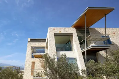 a building with a staircase on the side of it at New Luxury Olives & Thyme Retreat, Seaview with 2 Heated Pools in Chania Town