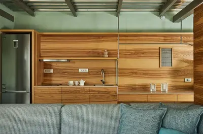 a living room with a couch and a wooden wall at New Luxury Olives & Thyme Retreat, Seaview with 2 Heated Pools in Chania Town