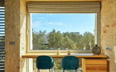 two chairs sitting in front of a large window at New Luxury Olives & Thyme Retreat, Seaview with 2 Heated Pools in Chania Town
