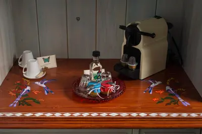 a table with a figurine and a bottle on it at Dream Art Studios in Chania Town