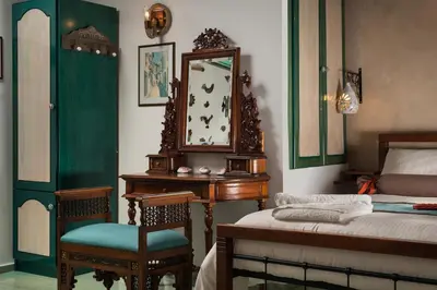 a bedroom with a bed and a desk and a mirror at Dream Art Studios in Chania Town