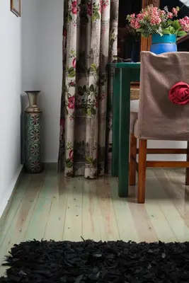 a dining room with a table and a chair and a table and curtains at Dream Art Studios in Chania Town