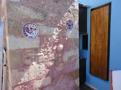 a wall with plates on it next to a door at Dream Art Studios in Chania Town