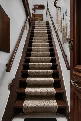 a winding staircase with wooden railings and carpet at Dream Art Studios in Chania Town