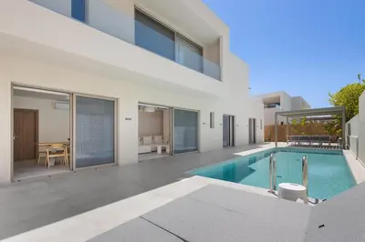 an exterior view of a house with a swimming pool at Sea Princessa Villa in Chania Town