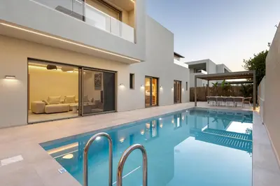 a swimming pool in the backyard of a house at Sea Princessa Villa in Chania Town