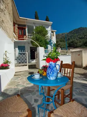 a blue table with a vase on a patio at Polidoros vintage house 13 km from Elafonisi in Vathi