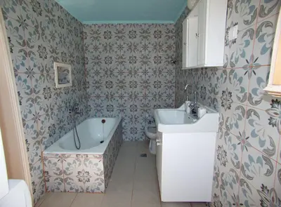 a bathroom with a tub and a sink at Polidoros vintage house 13 km from Elafonisi in Vathi