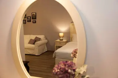 a bedroom with a bed and a mirror at Shalom Luxury Rooms Kondilaki in Chania Town