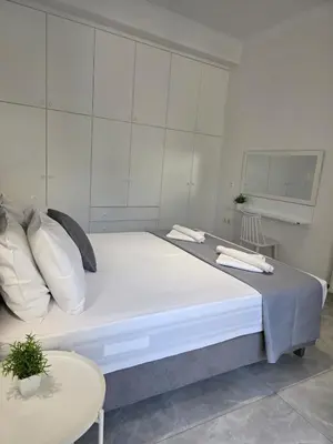 a large bed in a room with a table at Olive Angel 1 in Chania Town