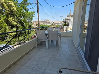 a patio with chairs and a table on a balcony at Olive Angel 1 in Chania Town
