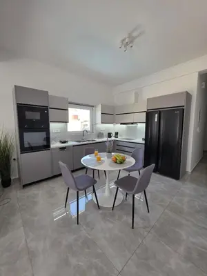 a kitchen with a table and chairs in a kitchen at Olive Angel 1 in Chania Town
