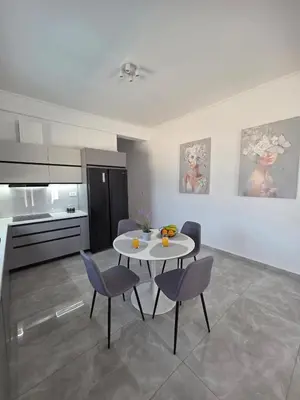 a kitchen and dining room with a table and chairs at Olive Angel 1 in Chania Town