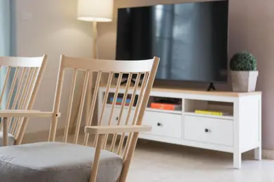 a living room with two chairs and a tv at Blue Haven Chania Apt in Chania Town