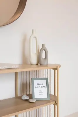 a shelf with vases and a sign on it at Blue Haven Chania Apt in Chania Town