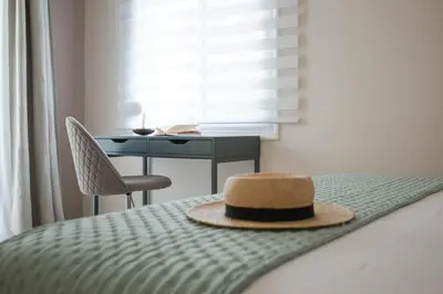 a hat sitting on top of a bed with a desk at Blue Haven Chania Apt in Chania Town