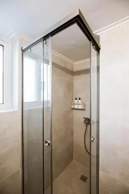 a shower with a glass door in a bathroom at Blue Haven Chania Apt in Chania Town