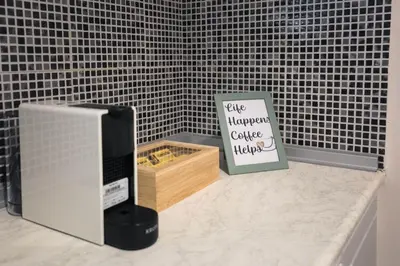 a kitchen counter with a sign and a box of food at Blue Haven Chania Apt in Chania Town