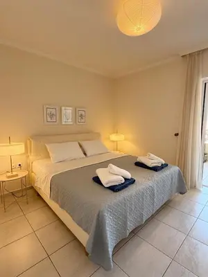a bedroom with a large bed with towels on it at Chania Memories Apartment in Chania Town