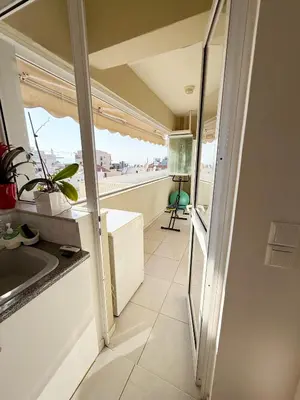 a view of a kitchen with a window and a sink at Chania Memories Apartment in Chania Town