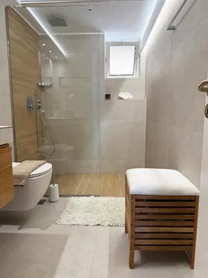 a bathroom with a shower and a toilet and a sink at Chania Memories Apartment in Chania Town