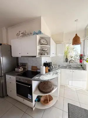 a kitchen with white cabinets and a counter top at Chania Memories Apartment in Chania Town