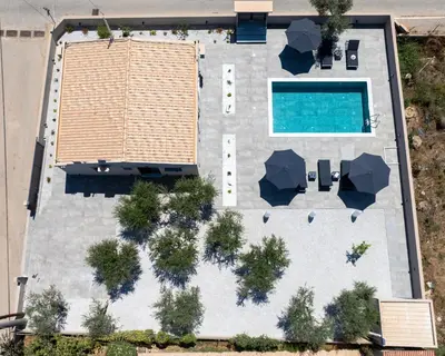 an overhead view of a building with a swimming pool at Glafkos house with pool near the beach in Daratso