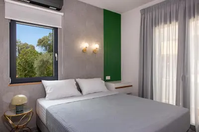 a bedroom with a large bed and a window at Glafkos house with pool near the beach in Daratso