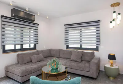 a living room with a couch and a table at Glafkos house with pool near the beach in Daratso