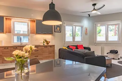 a living room with a couch and a table at Sylvie Comfort Living in Chania Town
