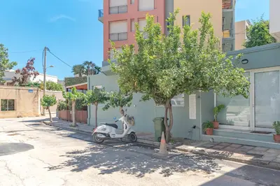 a scooter parked next to a tree next to a building at Sylvie Comfort Living in Chania Town