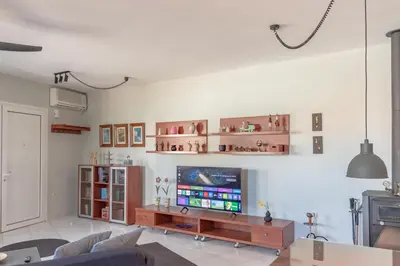 a living room with a flat screen tv on a wall at Sylvie Comfort Living in Chania Town
