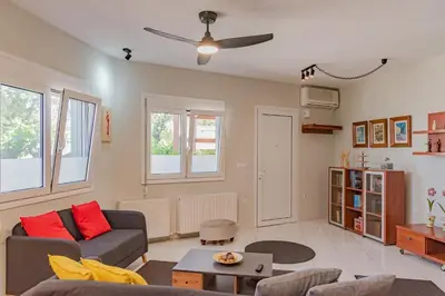 a living room with a couch and a table at Sylvie Comfort Living in Chania Town