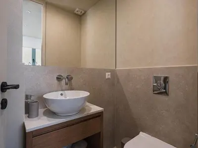 a bathroom with a white sink and a mirror at Off Apartments in Chania Town