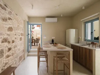 a kitchen with a table with chairs and a refrigerator at Off Apartments in Chania Town