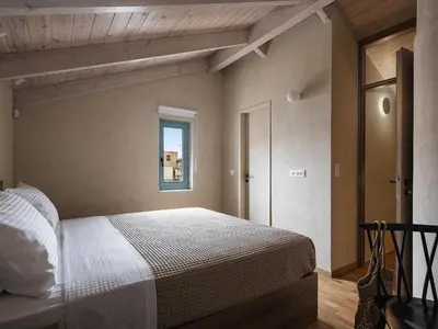 a bedroom with a bed and a window at Off Apartments in Chania Town