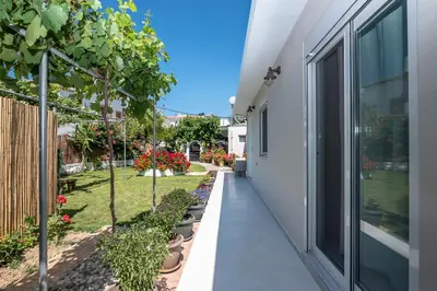 a walkway outside of a house with plants at Garden House 2 in Kissamos