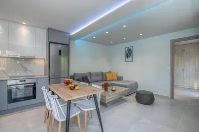 a kitchen and living room with a table and a couch at Garden House 2 in Kissamos