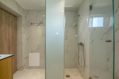 a bathroom with a shower with a glass door at Garden House 2 in Kissamos
