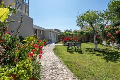 a garden with a table and chairs and flowers at Garden House 2 in Kissamos