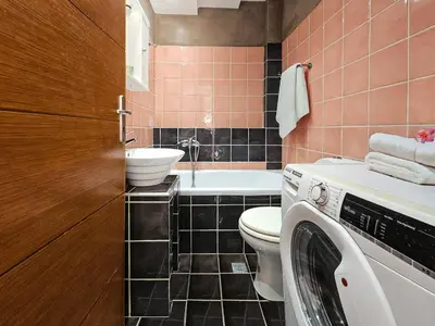 a bathroom with a washer and a washing machine at Dafne Almyrida Beach Apartment in Almirida