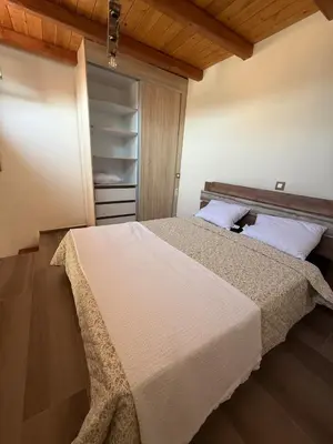 a bedroom with a large bed and a closet at Stay near Balos & the seaside in Kaloudhianá