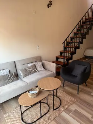 a living room with a couch and a table at Stay near Balos & the seaside in Kaloudhianá