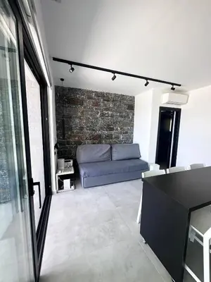 a living room with a couch and a brick wall at Astrokastro Frangokastello in Frangokastello
