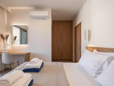 a bedroom with a bed with towels on it at Aurea Beach Villa in Kato Daratso